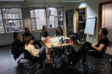 A group of people sits around a table